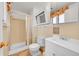 Bathroom features a shower with a curtain and a medicine cabinet at 2826 S Lamar St, Denver, CO 80227