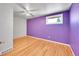 Bedroom with hardwood floors features a ceiling fan and window at 2826 S Lamar St, Denver, CO 80227