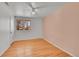 This bedroom features gleaming hardwood floors and a ceiling fan at 2826 S Lamar St, Denver, CO 80227