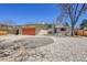 Charming ranch-style home with an orange garage door and landscaped front yard at 2826 S Lamar St, Denver, CO 80227