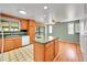 Well-lit kitchen with an island, wood cabinets and modern appliances at 2826 S Lamar St, Denver, CO 80227