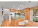Open kitchen with an island, white appliances, and access to outdoor patio at 2826 S Lamar St, Denver, CO 80227