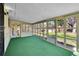 Enclosed sunroom filled with windows and a green carpet at 2826 S Lamar St, Denver, CO 80227