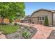 Beautifully landscaped backyard with stone patio, lush gardens, swing, mature trees, and privacy fence at 21107 Hawthorne Ln, Parker, CO 80138