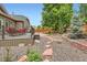 Lush backyard with a patio dining set, gravel, stone walkways and privacy fence at 21107 Hawthorne Ln, Parker, CO 80138
