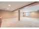 Spacious basement features neutral carpet, columns, and ample natural light at 21107 Hawthorne Ln, Parker, CO 80138