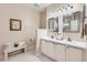 Well-lit bathroom with a double sink vanity, white cabinets, and decorative accents at 21107 Hawthorne Ln, Parker, CO 80138