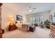 Spacious bedroom with neutral carpet, a ceiling fan, and a cozy sitting area with an upholstered chair at 21107 Hawthorne Ln, Parker, CO 80138