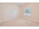Bedroom with soft, neutral carpet, a window with plantation shutters, and neutral colored walls at 21107 Hawthorne Ln, Parker, CO 80138