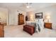Comfortable bedroom with neutral walls, a ceiling fan, soft carpet, and a cozy quilt at 21107 Hawthorne Ln, Parker, CO 80138