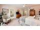 Spacious bedroom with neutral walls and carpet, wood furniture, and a view into the ensuite bathroom at 21107 Hawthorne Ln, Parker, CO 80138