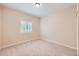 Cozy bedroom with neutral carpet, a window with plantation shutters, and neutral colored walls at 21107 Hawthorne Ln, Parker, CO 80138