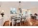Bright dining room with stylish table and chairs, hardwood floors, and modern lighting at 21107 Hawthorne Ln, Parker, CO 80138