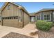Exterior of a home with a lush green lawn and charming stone facade details at 21107 Hawthorne Ln, Parker, CO 80138