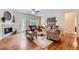 Bright living room with hardwood floors, fireplace, ceiling fan, and stylish furnishings at 21107 Hawthorne Ln, Parker, CO 80138