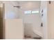 Modern walk-in shower with white tiled walls, bench seating, a rainfall shower head, and a window at 21107 Hawthorne Ln, Parker, CO 80138