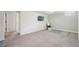 Finished basement featuring neutral carpet, a wall-mounted TV, and access to additional rooms at 3285 S Delaware St, Englewood, CO 80110