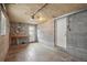 Unfinished basement space with concrete walls, lighting, and access doors at 3285 S Delaware St, Englewood, CO 80110