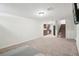 Finished basement with carpeted floors, open to kitchenette and staircase to the main floor at 3285 S Delaware St, Englewood, CO 80110