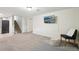 Finished basement with neutral carpet, a wall-mounted TV, and staircase to the upper level at 3285 S Delaware St, Englewood, CO 80110