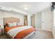 Comfortable bedroom with a decorative wall, soft carpet, and access to the ensuite bathroom at 3285 S Delaware St, Englewood, CO 80110