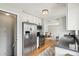 Well-lit kitchen with stainless steel appliances and white cabinets, open to the living space at 3285 S Delaware St, Englewood, CO 80110