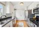 Kitchen featuring modern appliances, granite countertops, and hardwood floors at 3285 S Delaware St, Englewood, CO 80110