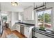 Kitchen featuring white cabinets, stainless steel appliances, and hardwood floors at 3285 S Delaware St, Englewood, CO 80110