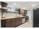 Well-lit kitchen featuring wooden cabinets, stainless steel appliances, and stylish countertops at 3285 S Delaware St, Englewood, CO 80110