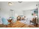 Open concept living space with a glass table, a sofa, and hardwood floors at 3285 S Delaware St, Englewood, CO 80110