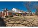 Expansive backyard view with a large lawn, mature trees, brick exterior, and covered patio at 3926 S Magnolia Way, Denver, CO 80237