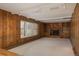 Wood-paneled living room with a brick fireplace, built-in shelves, and large windows with lots of natural light at 3926 S Magnolia Way, Denver, CO 80237