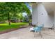 Patio area with outdoor seating and a glimpse of the lush green lawn and mature trees at 5853 S Havana Ct, Englewood, CO 80111