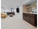 Spacious finished basement with modern wet bar, built-in cabinets, neutral color palette, and plush seating at 5853 S Havana Ct, Englewood, CO 80111