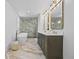 Bright bathroom featuring double vanity, soaking tub, and glass shower at 5853 S Havana Ct, Englewood, CO 80111