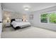 Bright main bedroom featuring a window, bed with white linens and simple decor at 5853 S Havana Ct, Englewood, CO 80111