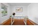 Bright office space featuring light wood floors, white walls, and minimalist decor at 5853 S Havana Ct, Englewood, CO 80111