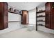 Walk-in closet featuring wood shelving and carpet floors at 5853 S Havana Ct, Englewood, CO 80111