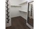 Well-organized walk-in closet with dark wood floors and hanging shelves for storage at 13788 Umatilla Ln, Broomfield, CO 80023