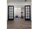 Bright exercise room with French doors, fitness equipment, and modern flooring at 13788 Umatilla Ln, Broomfield, CO 80023