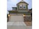 A two-car garage with a stone facade is visible on this house at 13788 Umatilla Ln, Broomfield, CO 80023