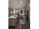 Modern kitchen with gray cabinets, quartz countertops, stainless steel appliances, and a center island at 13788 Umatilla Ln, Broomfield, CO 80023