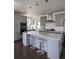 Modern kitchen with gray cabinets, quartz countertops, stainless steel appliances, and a center island at 13788 Umatilla Ln, Broomfield, CO 80023