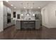 Modern kitchen with gray cabinets, quartz countertops, stainless steel appliances, and a center island at 13788 Umatilla Ln, Broomfield, CO 80023