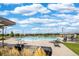A pool with lounge chairs and shade is visible on a sunny day at 13788 Umatilla Ln, Broomfield, CO 80023