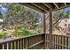 Cozy balcony overlooking a lush, green courtyard with mature trees and a winding walkway at 9995 E Harvard Ave # 290, Denver, CO 80231