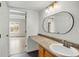 Bathroom sink with mirror, and doorway leading to a bedroom at 9995 E Harvard Ave # 290, Denver, CO 80231