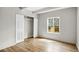 Bright bedroom featuring wood floors, closet, and a window with natural light at 9995 E Harvard Ave # 290, Denver, CO 80231