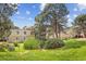 Exterior shot of a building surrounded by lush greenery, mature trees, and well-maintained lawn at 9995 E Harvard Ave # 290, Denver, CO 80231