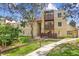 Inviting exterior of a multi-level home with private balconies and lush landscaping at 9995 E Harvard Ave # 290, Denver, CO 80231
